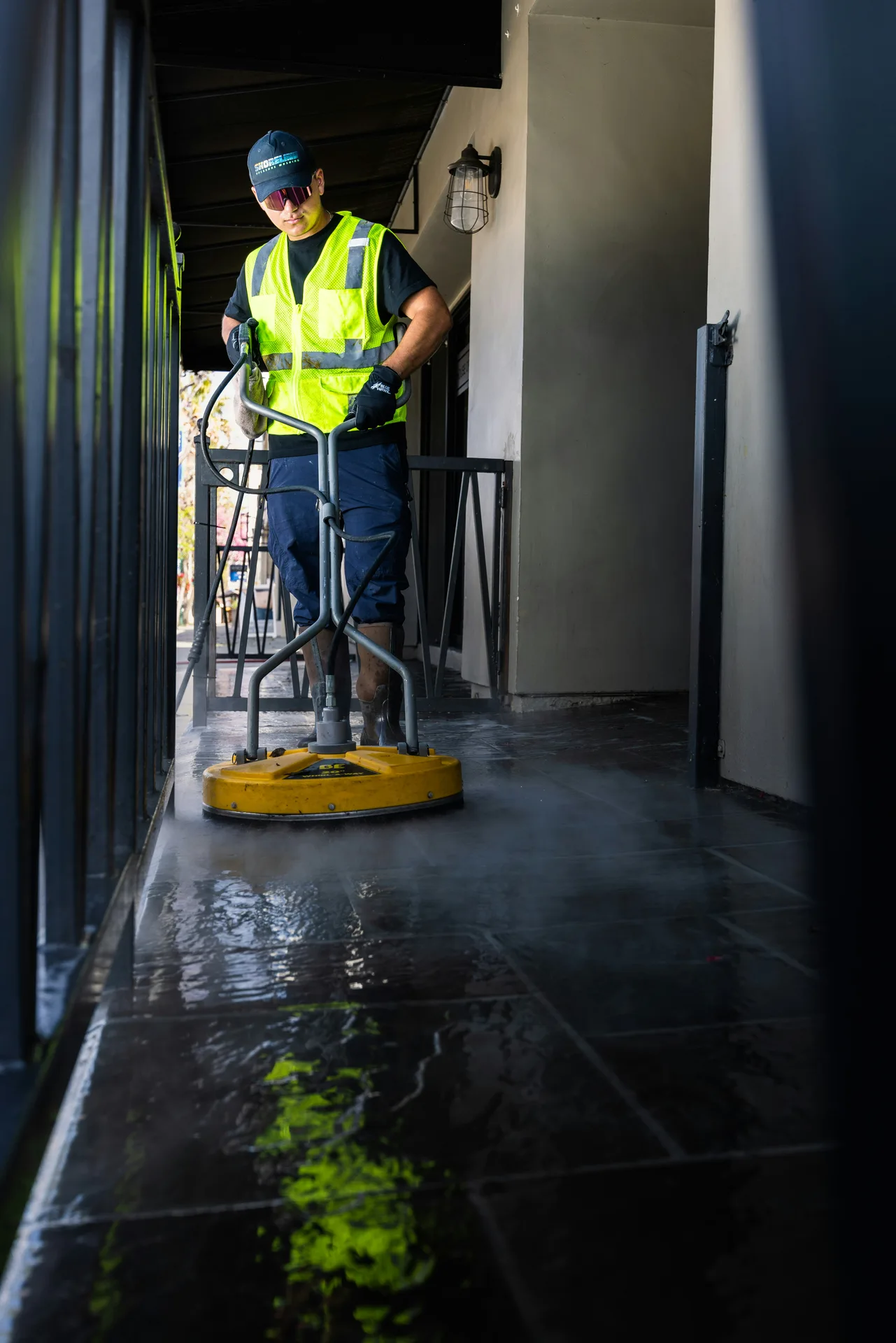 Technician Using Surface Cleaner on /oil-stain-removal/ — Hamilton Pressure Washing Hamilton